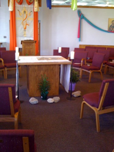 Rocks surround the altar and sit on chairs at St Nicholas Church
