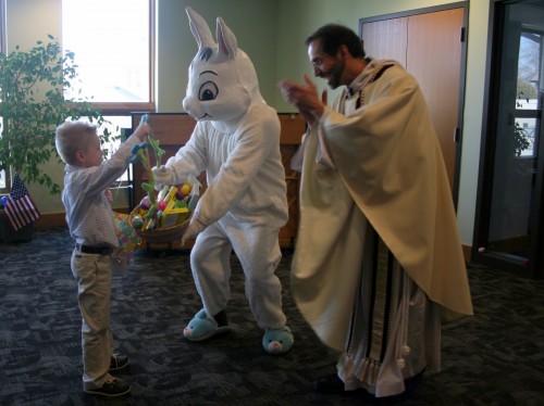 The Easter Bunny rewards Jack for finding the Golden Egg as Father Manny Borg looks on